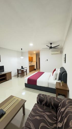 a bedroom with a bed and a living room at Damai Laut Serene Stay Studio Lumut in Lumut