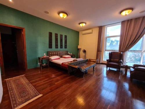 a bedroom with a bed and a table in a room at Hill Cottage in Moshi