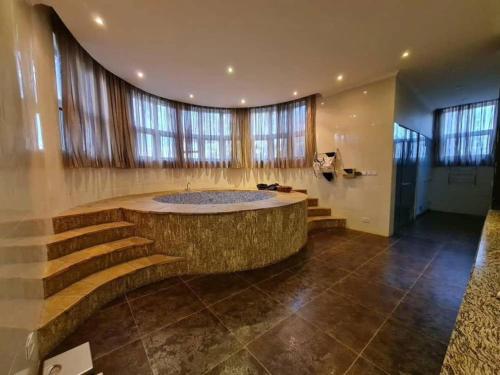 a large room with a large tub in a building at Hill Cottage in Moshi
