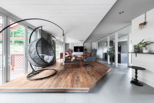 a living room with a large swing in the middle at The Elysian Retreat in Otaru