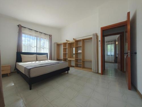a bedroom with a bed and a room with shelves at Isola Riambel in Riambel