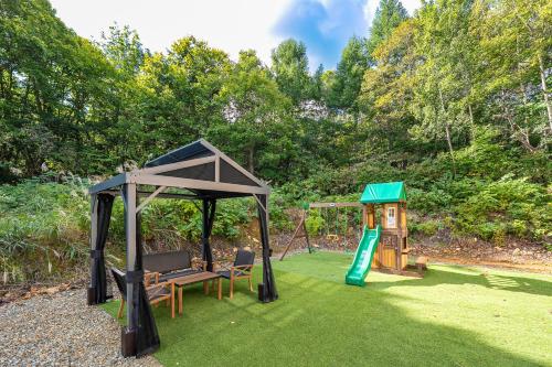 a playground with a bench and a swing at The Elysian Retreat in Otaru
