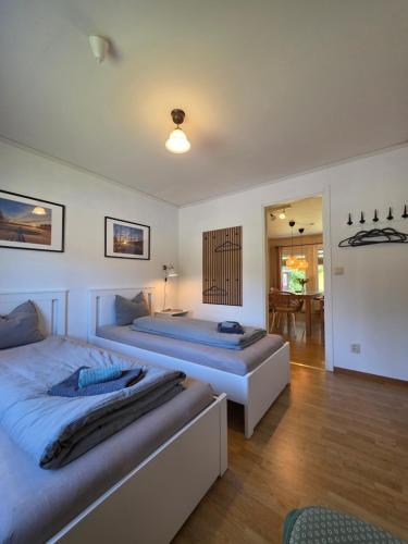 a bedroom with two beds and a dining room at Villa Edda in Vidsel