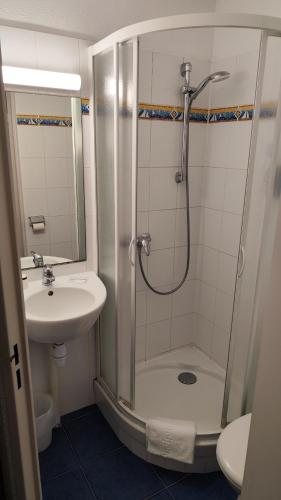 a bathroom with a shower and a sink at BRIT HOTEL Caen Hérouville in Hérouville-Saint-Clair