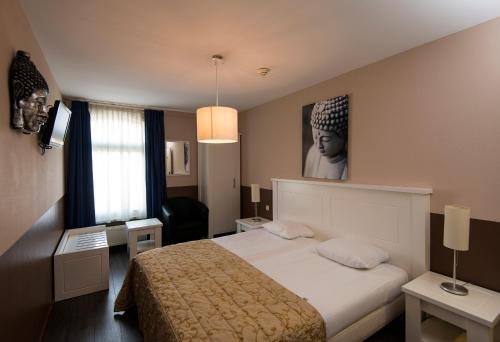 A bed or beds in a room at Het Hart van Weesp