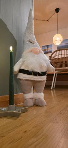 a stuffed animal sitting on the floor next to a candle at Villa Edda in Vidsel