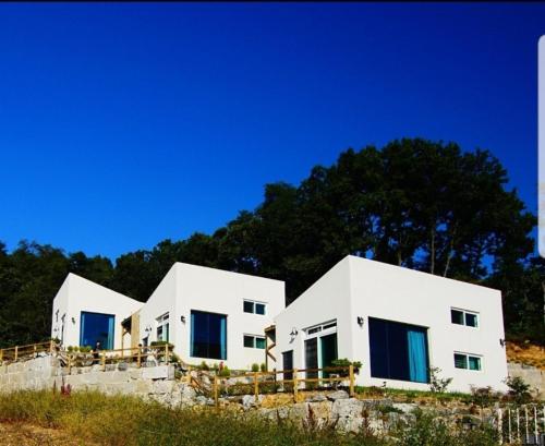 a row of white houses on top of a hill at ganghwa mj hauseu in Incheon