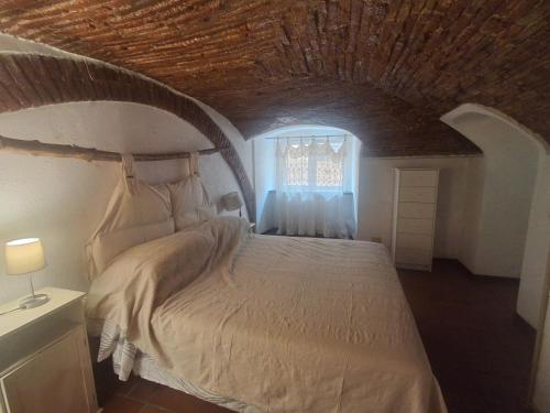 a bedroom with a large bed with a wooden ceiling at I Mattoni Rossi in Imperia