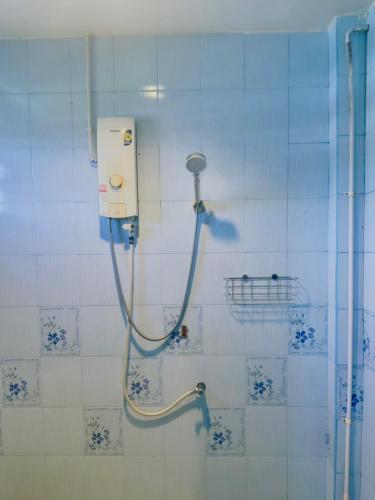 a shower with a hose attached to a wall at Apartment X5 in Pattaya South