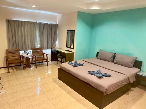 a bedroom with a large bed and a desk at Apartment X5 in Pattaya South
