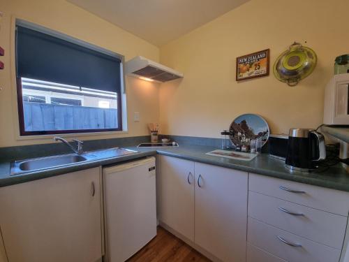 a kitchen with a sink and a window at #6 Glenorchy Alpine Suite in Glenorchy