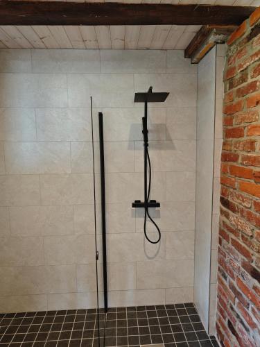 a shower stall with a cross on the wall at Nature Reserve Hideaway in Nohipalu
