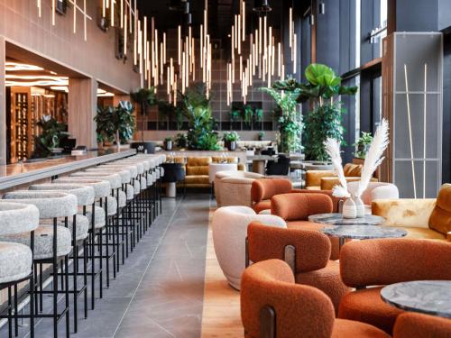 a lobby with a row of chairs and tables at Pullman Lyon in Lyon
