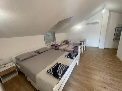 a bedroom with three beds in a room at Amra in Počitelj
