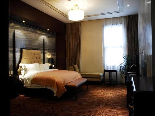 a bedroom with a large bed and a window at Lhasa Hotel in Lhasa