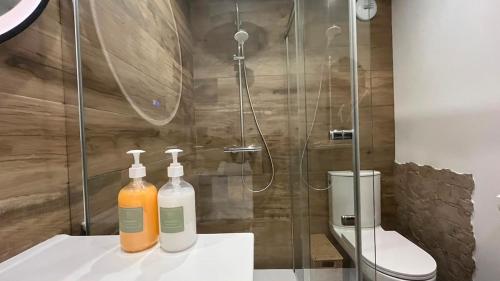 two bottles of soap on a counter in a bathroom at L'Appart' in Bruz