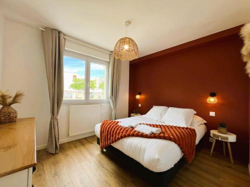 a bedroom with a large bed and a window at L'Appart' in Bruz