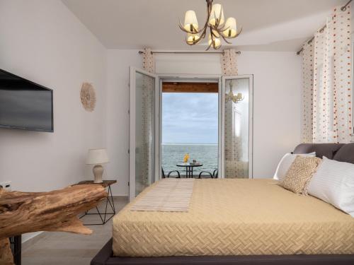 a bedroom with a bed and a view of the ocean at Marelia Memories villa in Skaleta