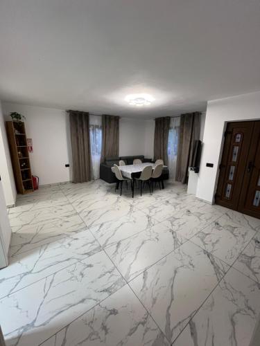 a living room with a marble floor and a table at Căsuța Găvruj in Săcel