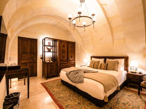a bedroom with a bed and a piano in a room at Cybele in Cappadocia in Uçhisar