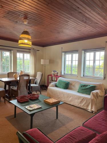 a living room with a couch and a table at Casas do Alpendre in Óbidos