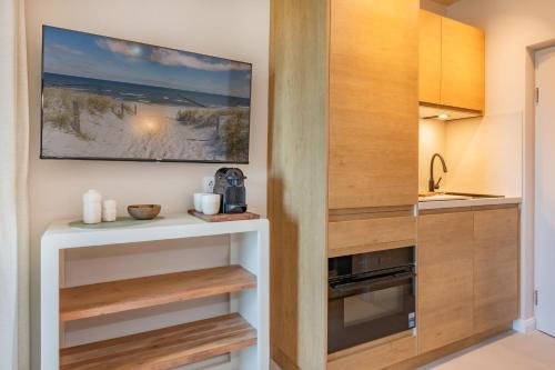 a kitchen with wooden cabinets and a tv on the wall at BALI BLIZZ - App 14 in Benz
