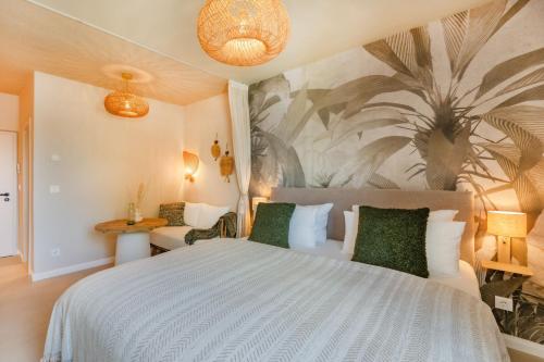 a bedroom with a white bed with a palm mural at BALI BLIZZ - App 16 in Benz