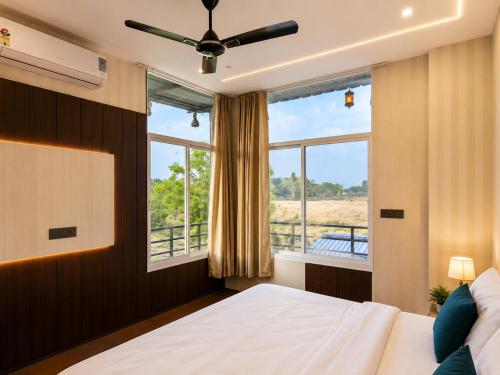 a bedroom with a bed and a large window at Atithi Farms - 4 BHK Farm Villa with Private Pool in Thūr