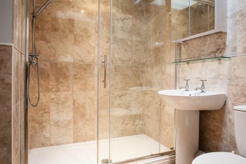 a bathroom with a shower and a sink and a toilet at Fig Cottage, near Bradford on Avon and Bath in Holt