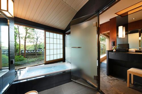 a large bathroom with a tub and a window at Gajoen Tokyo in Tokyo