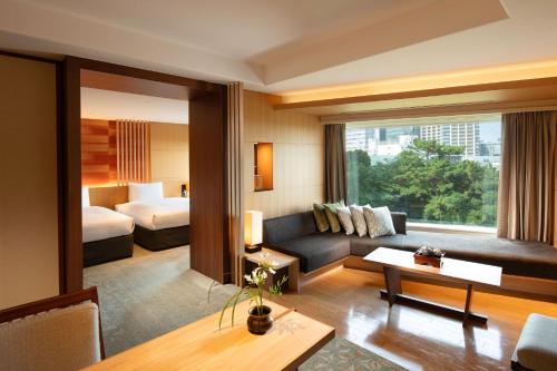 a hotel room with a couch and a bed at Gajoen Tokyo in Tokyo
