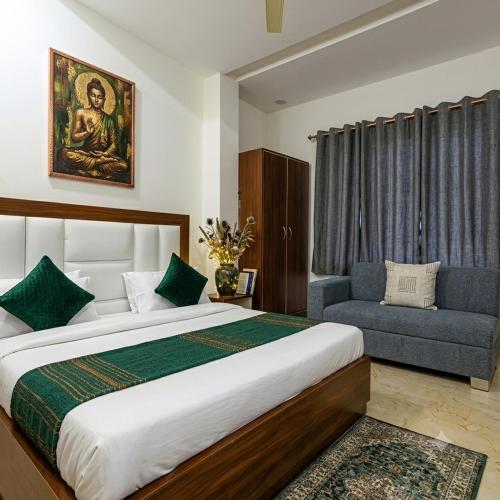 a bedroom with a large bed and a chair at Hotel Grand Heaven in Tājganj