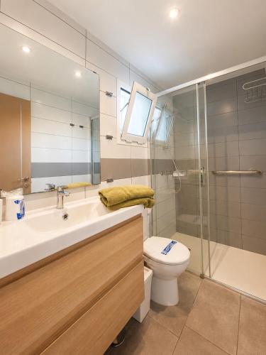 a bathroom with a sink and a toilet and a shower at Alsol Los Leones Bungalows - Adults Only in Maspalomas