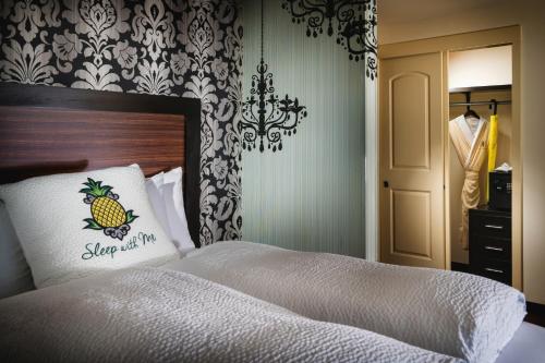 a bedroom with a bed with a pineapple pillow on it at Staypineapple, The Maxwell Hotel, Seattle Center Seattle in Seattle