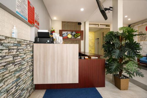 a lobby with a reception desk in a building at Collection O near Tunjungan Plaza formerly K15 in Kedongdong