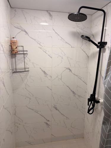 a shower with a glass door in a bathroom at Hostel 1869 in Karakol