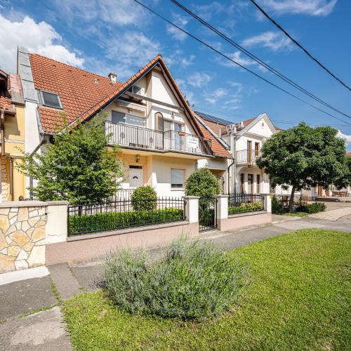 a house with a fence and a yard at Gere Apartment de Luxe in Harkány