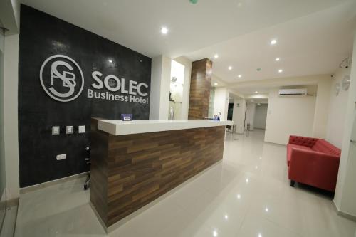 a lobby of a building with a sign for a company at Hotel Solec in Chiclayo