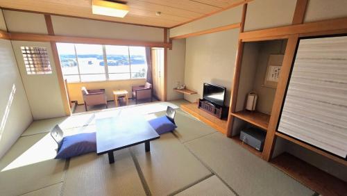 a living room with a couch and a table at 賢島の宿みち潮 Kashikojima no yado Michishio in Shima