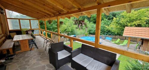 a screened in porch with a view of a swimming pool at Vila Žubor in Crni Vrh
