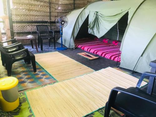 a tent with a pink bed in a room at Sri Craft Algama in Uduwaka