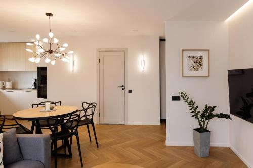 a dining room and living room with a table and chairs at AN apartment 5 in Rēzekne