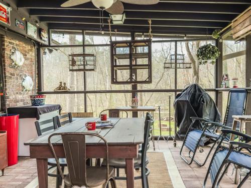 a patio with tables and chairs in a building at A Charming Nature Retreat in Greensboro