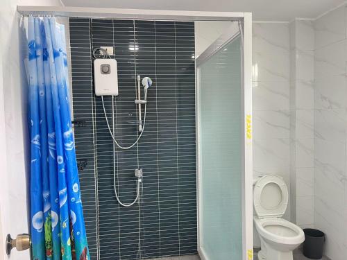 a shower in a bathroom with a toilet at Bolabog Beach Resort in Boracay