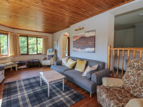 a living room with a couch and a table at Allt An Dorran in Acharacle