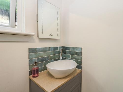 a bathroom with a bowl sink on a counter at Allt An Dorran in Acharacle