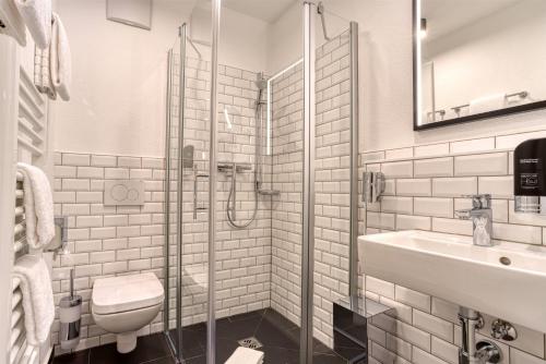 a bathroom with a glass shower and a sink at AVA Boutique Hotel in Ingolstadt