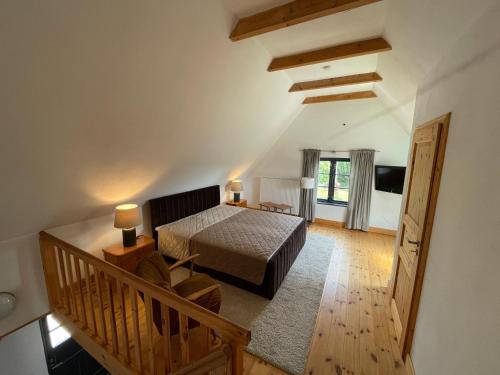 a view of a bedroom with a bed and a staircase at Kachelofenhaus in Fehmarn