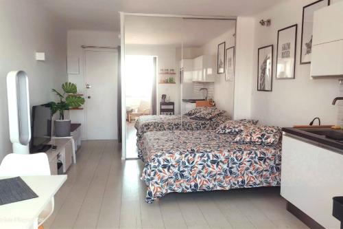 a bedroom with two beds and a sink in it at 27m with terrace - first row sea view in Six-Fours-les-Plages