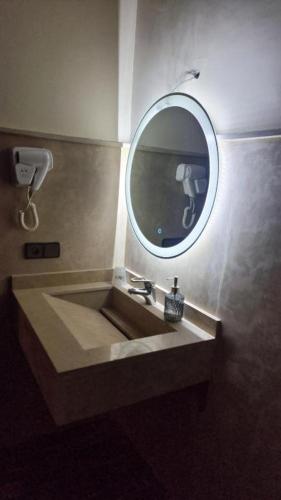 a bathroom with a sink and a mirror at Le Paisible Atlas in Marrakesh